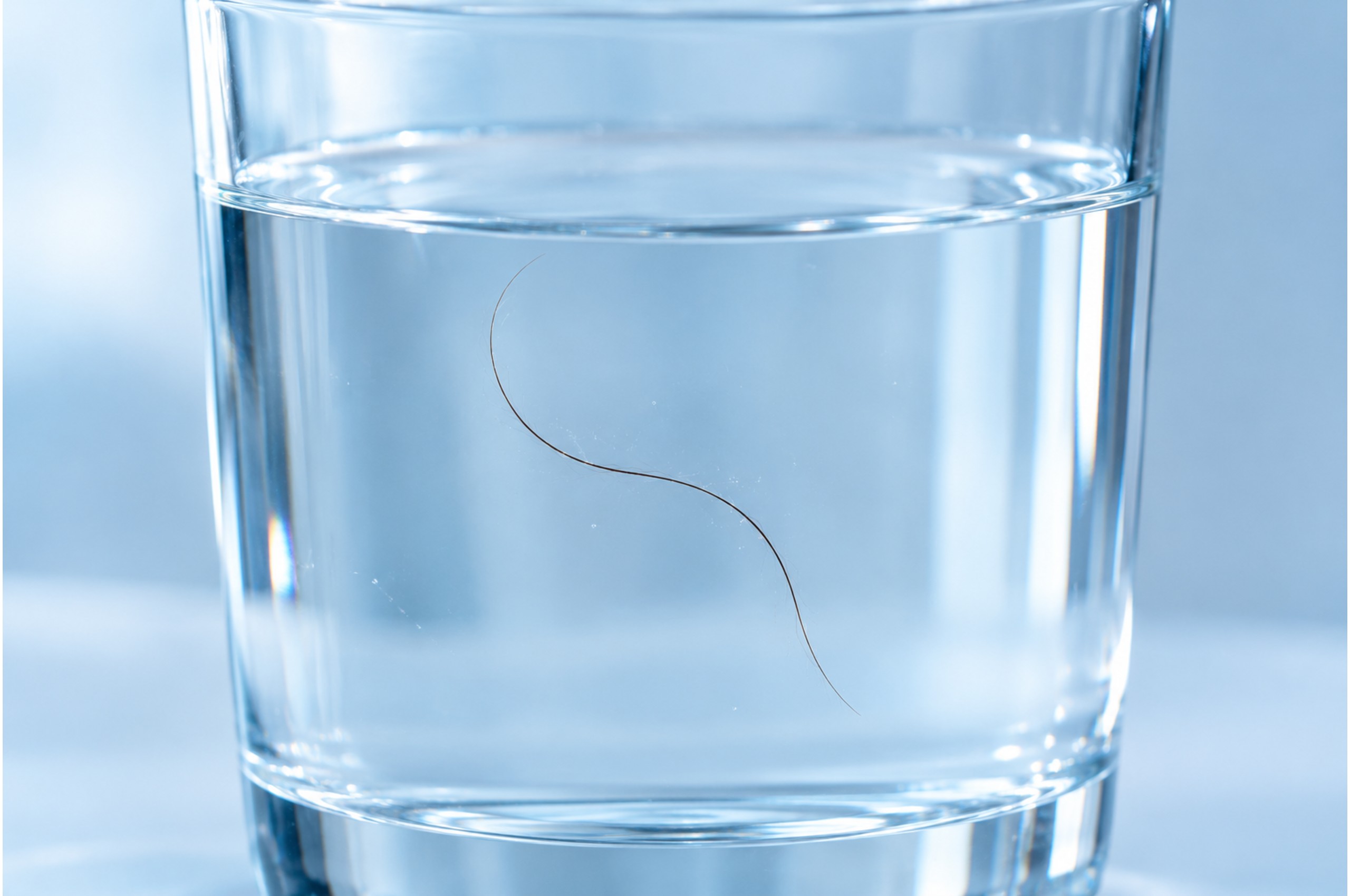 Hair strand floating in water to test hair porosity level